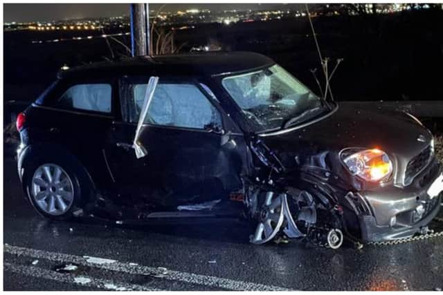 A black Mini was left heavily damaged after being involved in a collision. Photo: Police Scotland
