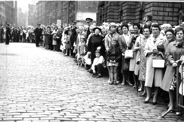A crowd of several hundred line the High Street from the City Chambers to St Giles Cathedral to watch the traditional procession to mark the opening of the Edinburgh International Festival in 1962.
