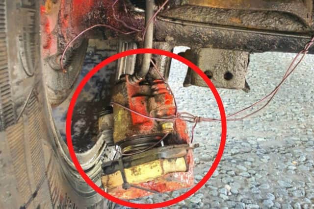 After clambering under the vehicle to take a closer look, one officer realised the dangling object was the brake caliper from one of the rear wheels, which had been fixed in place with copper wiring.