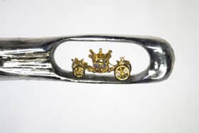 Micro-sculptor Dr Willard Wigan created this tiny model of the Queen's Coronation Carriage which fits inside the eye of a needle.