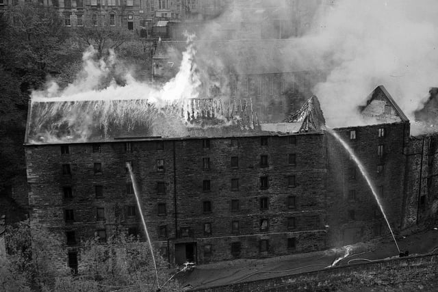 Flames can be seen here rising from a fire that broke out at the warehouse of theatrical costumiers William Mutrie and Son at Bells Brae in Dean Village. Year: 1957
