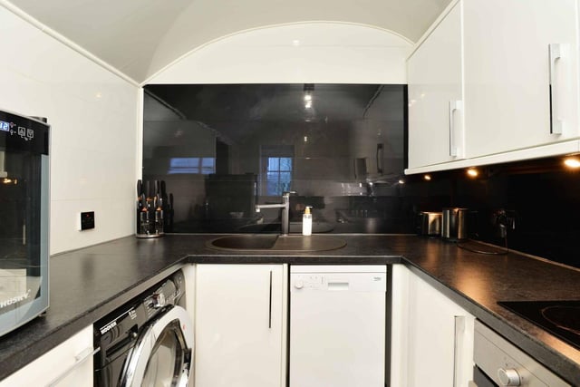 The fully-equipped modern kitchen; With electric hob, fan oven and white goods.