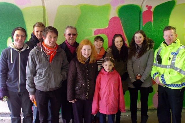 Subway walls were the setting for this art competition in 2013. Pictured are Coun. Harry Truman (4th left) with subway art design competition winners Emma Defty (10) (5th left) and Rebekah Wilson (11)  (6th left) both pupils at St. John Boste RC School, Oxclose Washington,  with Insp. Paul Stewart (right) and members of the Oxclose & District Youth Project, who were painting the winning designs on the the subway walls.