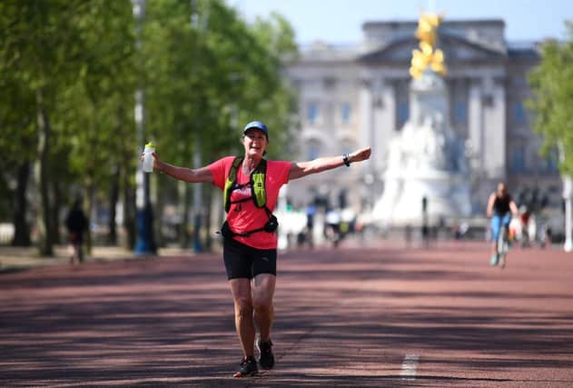A runner celebrates on the Mall , where the finish of the London Marathon was due to take place after running 2.6 miles instead of 26 miles to raise money for The Running Charity (Photo: Alex Davidson/Getty Images)