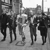 Punks and a Cyberman walking up Lothian Road to publicise the 20th anniversary Dr Who exhibition at the Filmhouse cinema in Edinburgh, December 1983.
