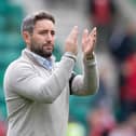 Lee Johnson applauds the Hibs fans at full time