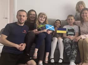L to R:Damian and Jennifer Gad, with Niamh on her lap. Alisa, Tomasz, Viktoriia and Valentyna (at back) at home in Bonnyrigg.