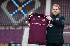 Hearts manager Robbie Neilson with the "new" sponsor.