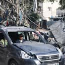 A man drives a damaged car through a street ravaged by Israeli bombing  in Rafah in the southern Gaza Strip on November 2 as battles between Israel and the Palestinian Hamas movement continue