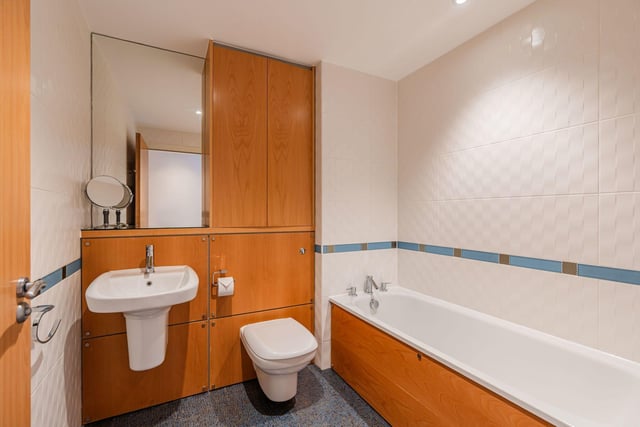 The tiled bathroom suite comes with a heated towel rail.