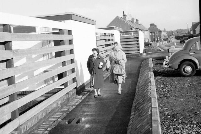 Two visitors walk around an experimental housing scheme set up at Prestonpans in October 1962.