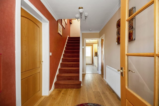 The hallway gives access to the downstairs room and a staircase leads to the upper floor.