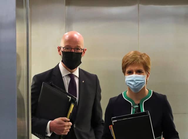 Scotland's First Minister Nicola Sturgeon and Education Minister John Swinney exit the lift. Picture: Russell Cheyne - WPA Pool/Getty Images