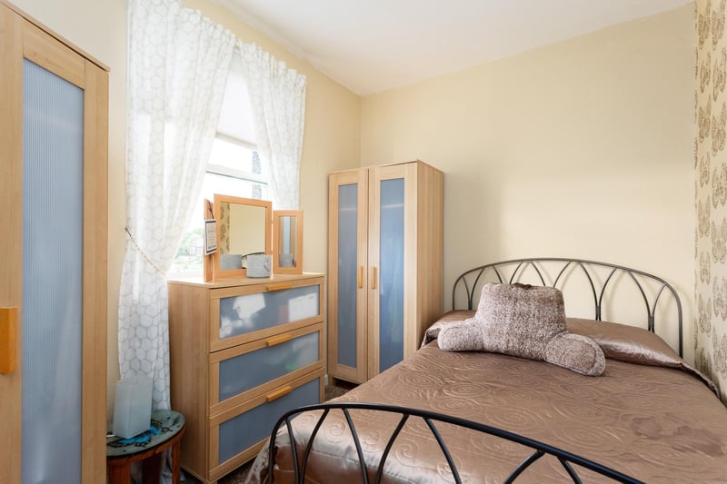 This good-sized bedroom features a large cupboard.