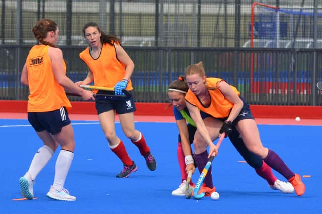 Sarah Jamieson (orange bib) shields the ball from Amy Costello in training with Scotland. They will be in opposition camps on Sunday. Picture by Nigel Duncan
