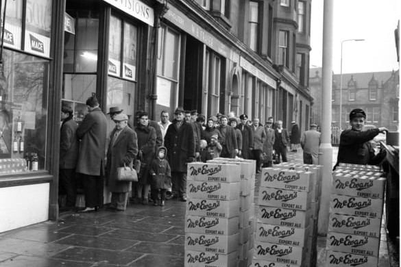 December 29, 1965: Customers queue outside Mr Munro's shop in Brandon Terrace, Stockbridge, eager to buy supplies for Hogmanay. Crates of McEwan's Export wait to be loaded inside.
