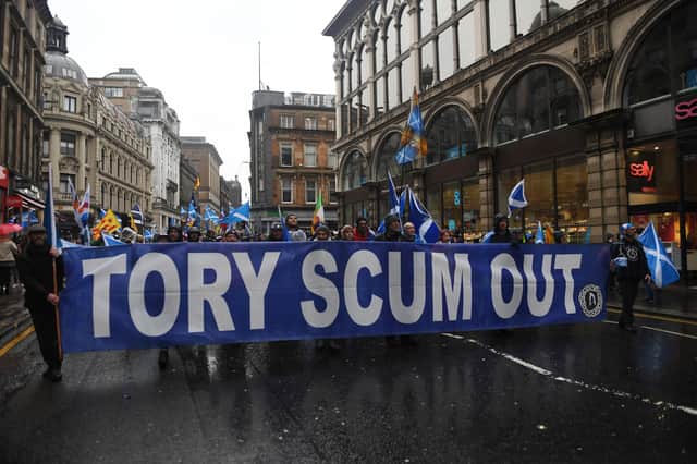 Pro-independence protesters hold a banner that reads 'Tory scum out' during a march organised by the All Under One Banner group in Glasgow last year (Picture: Andy Buchanan/AFP via Getty Images)