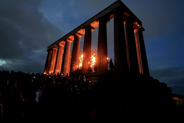 Thousands gathered to watch as the National Monument on Calton Hill was lit up with blazing torches.