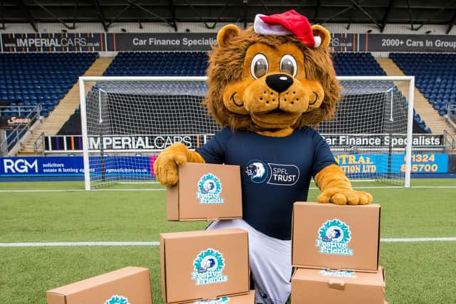 Lomond the Lion, mascot of SPFL trust with some festive hampers