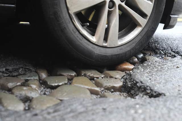 Edinburgh Council has announced money for road and pavement repairs that should have been addressed years ago, says John McLellan