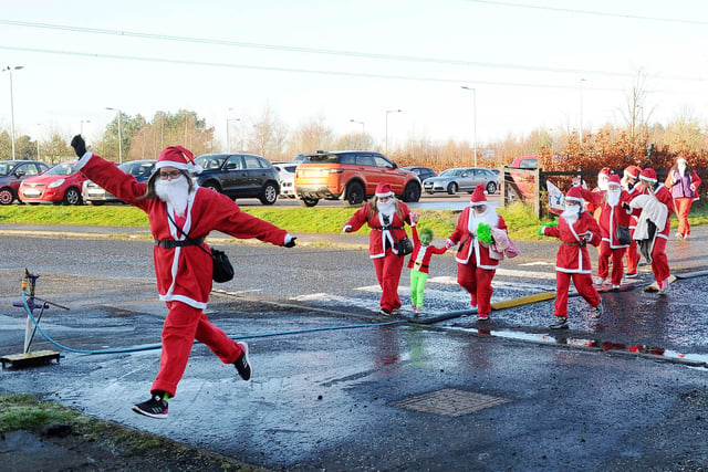 A Group of friends take part in charity Santa dash for Strathcarron Hospice around The Helix.