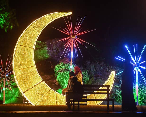 Women pose for a picture at Central Park (Hulhumalé) illuminated with decorations ahead of Eid al-Fitr festival, which marks the end of the holy fasting month of Ramadan, in Male in the Maldives on Monday. (Photo by Mohamed Afrah/Getty Images)