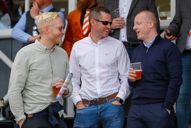 Racegoers take a break to have a chat and a drink with friends.