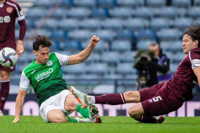 Peter Haring slides in with Joe Newell in the challenge which saw the Hibs midfielder sent off.