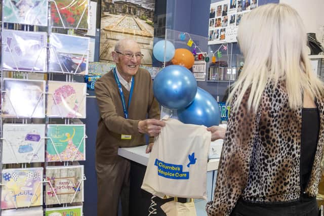 David is a big hit with the cancer charity shop's customeers