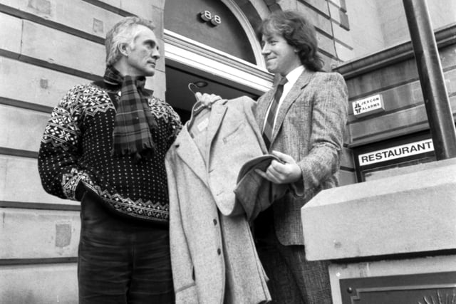 British film actor Terence Stamp (left) donates a suit he wore in 'Far from the Madding Crowd' to director Jim Hickey for Edinburgh's Filmhouse cinema auction to raise money for roof repairs in February 1987.