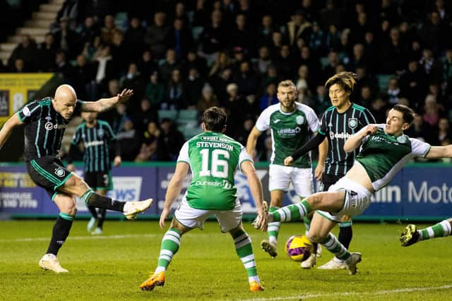 Hibs defenders are powerless to stop Aaron Mooy opening the scoring for Celtic at Easter Road. Picture: SNS