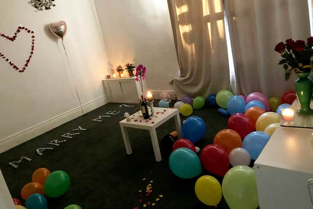 Albert  decided to surprise his sweetheart by filling their living room with over 100 candles and roughly 60 balloons, with the tealights spelling out: “Will You Marry Me?”. Picture: SWNS