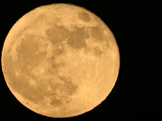 The "Strawberry supermoon" full moon rises on June 14, 2022 as seen from Lawndale, California. (Photo by Patrick T. FALLON / AFP) (Photo by PATRICK T. FALLON/AFP via Getty Images)