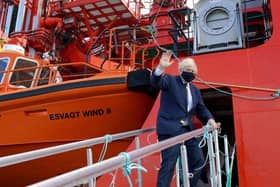 Boris Johnson boards the vessel Alba in Fraserburgh Harbour on his way to the Moray Offshore Windfarm East during his visit to Scotland
