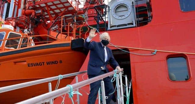 Boris Johnson boards the vessel Alba in Fraserburgh Harbour on his way to the Moray Offshore Windfarm East during his visit to Scotland