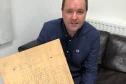 Neil Findlay with the plywood panel which contained his grandfather's story
