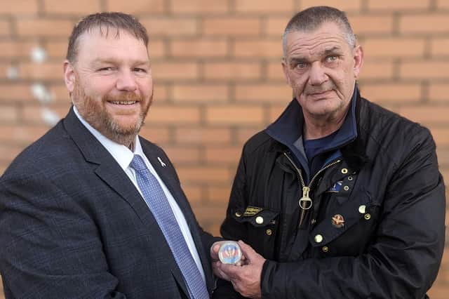 Midlothian MP Owen Thompson receives his challenge coin from Calum Macleod.