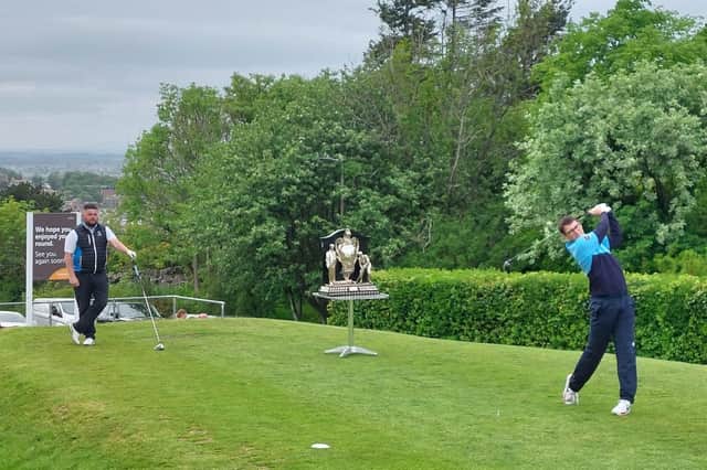 Duddingston's Jamie Duguid tees off at the first watcheed by Alan Mackay of Hailes in the third round of the 123rd Dispatch Trophy at the Braids. Picture: National World.