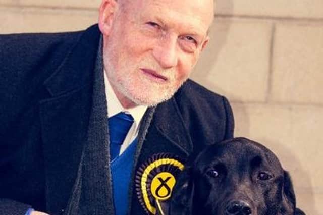 Councillor Derek Howie with his guide dog Lloyd