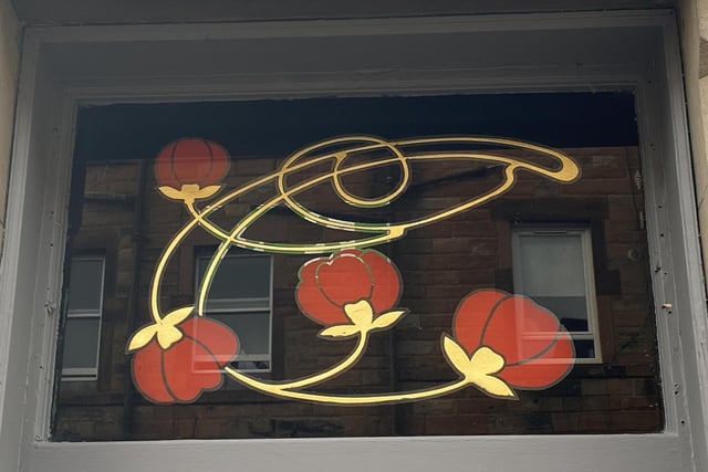 Above the doors is a glass panel that pays homage to the bar's years as the Bunch of Roses.