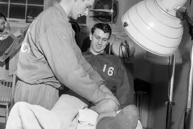 Eric Stevenson is pictured receiving treatment from Hibs trainer Tom McNiven at Easter Road in January 1964.