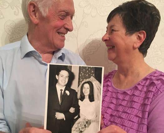 Denis and Mary Fell, both 73, with a photograph taken on their wedding day.