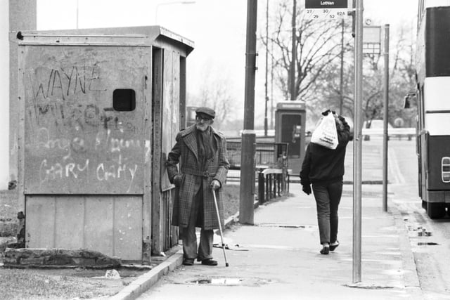 An old man waiting at a graffiti-covered bus stop in Pilton in March 1988.