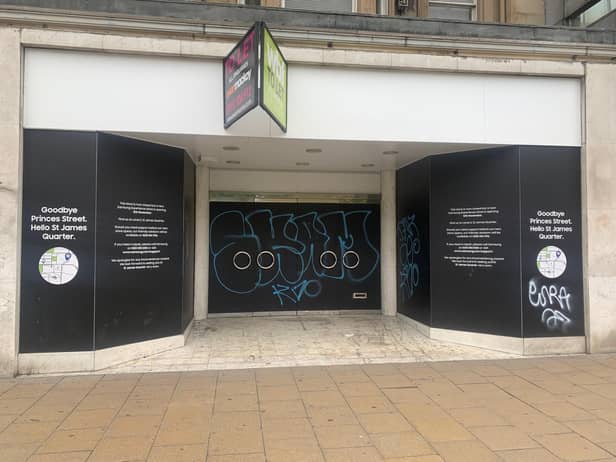 An empty shop tagged with graffiti on Princes Street