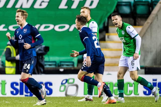 Hibs defender Paul McGinn shows his frustration as Ross County's Harry Paton (left) celebrates his opener during Wednesday night's defeat to Ross County at Easter Road. Photo by Ross Parker/SNS Group)
