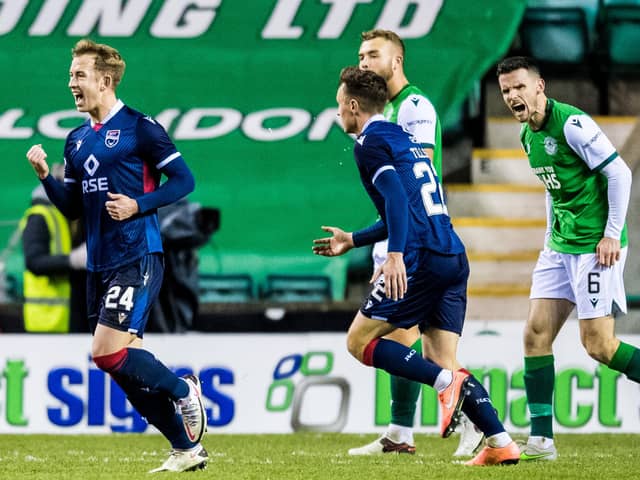 Hibs defender Paul McGinn shows his frustration as Ross County's Harry Paton (left) celebrates his opener during Wednesday night's defeat to Ross County at Easter Road. Photo by Ross Parker/SNS Group)