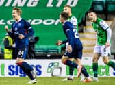 Hibs defender Paul McGinn shows his frustration as Ross County's Harry Paton (left) celebrates his opener during Wednesday night's defeat to Ross County at Easter Road. Photo by Ross Parker/SNS Group)