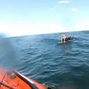 The two paddleboarders cried out to the RNLI crew, who helped them aboard the lifeboat.