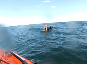 The two paddleboarders cried out to the RNLI crew, who helped them aboard the lifeboat.