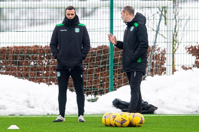 Jack Ross and John Potter deep in discussion during a Hibs training session ahead of the home match against Rangers